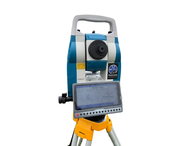 The PolyField Apeks AM02i total station on a yellow tripod, with its built-in touch screen